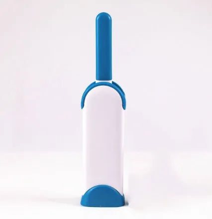Blue reusable pet hair removal comb with double-sided flannel brush and self-cleaning base for sofas.