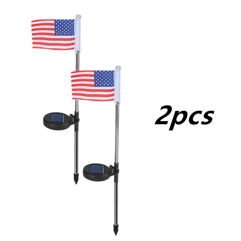 Solar garden flag light with stainless steel pole showing American flag design illuminated at night