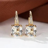 Square geometric ear hook earrings with zircon stones in an electroplated copper setting.