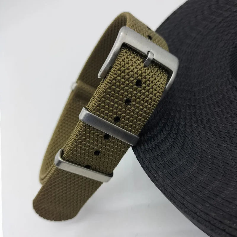 Nylon quick-release watch strap in army green, showing the integrated spring bar mechanism.