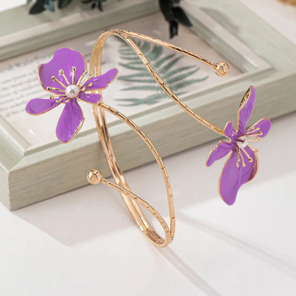 Pink alloy armband bracelet with hollow geometric linear pattern.