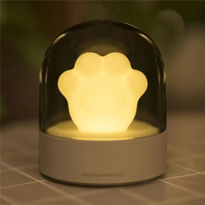 Grey cat paw shaped USB rechargeable night light with rotating musical display