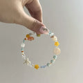 Orange sea coloured mixed material summer bracelet with diamond shape and round elements