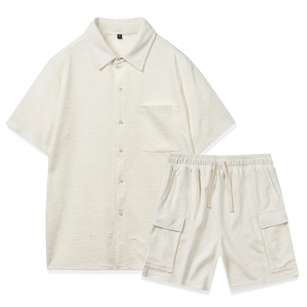 Plain grey polyester two-piece set with short sleeve top and elastic waist shorts laid flat.
