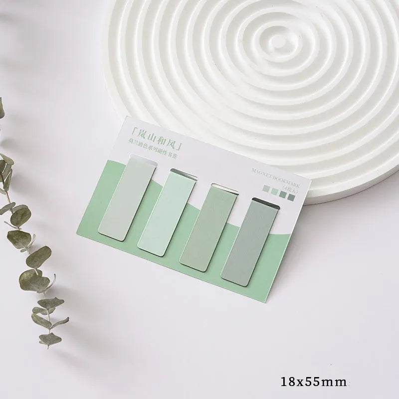 Set of four Morandi Series colour block magnetic bookmarks in pastel shades on a book page.