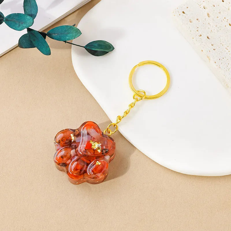 Natural crystal cat's paw keychain pendant in various gemstone colours including pink, red, blue, and green