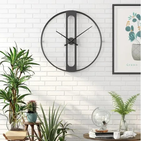Large 50cm round metal wall clock in black or gold finish on a wall