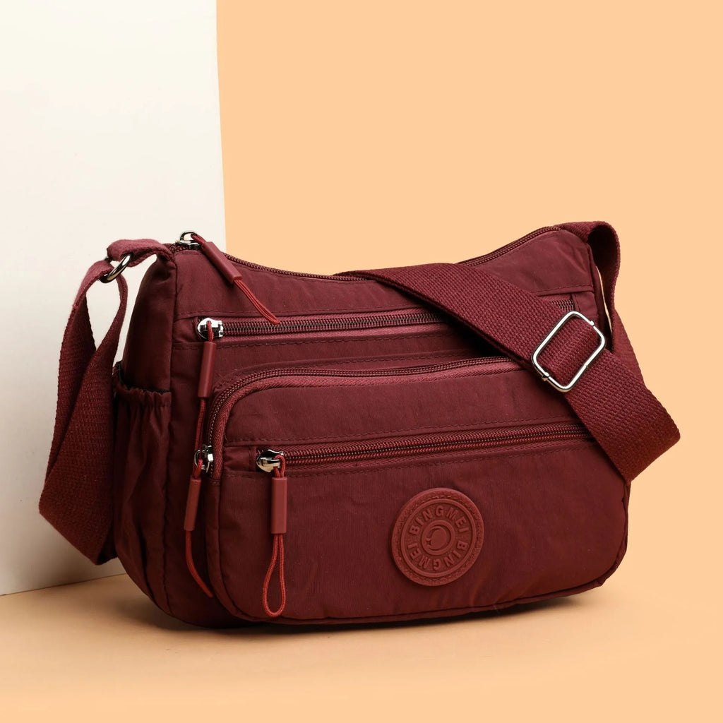 Trendy water-repellent nylon crossbody cloth bag in black with single shoulder strap and outer pocket