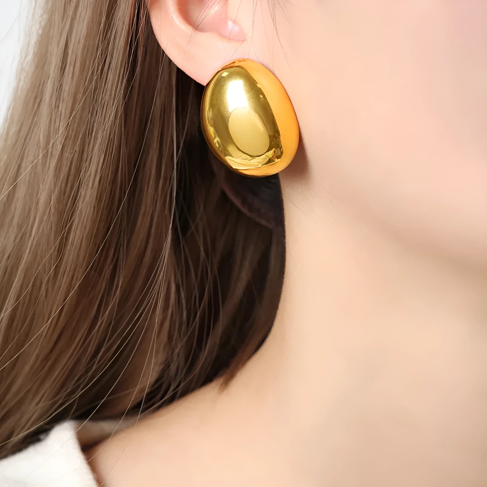 Geometric stainless steel ear studs with a glazed 18K gold electroplated finish and linear design details.
