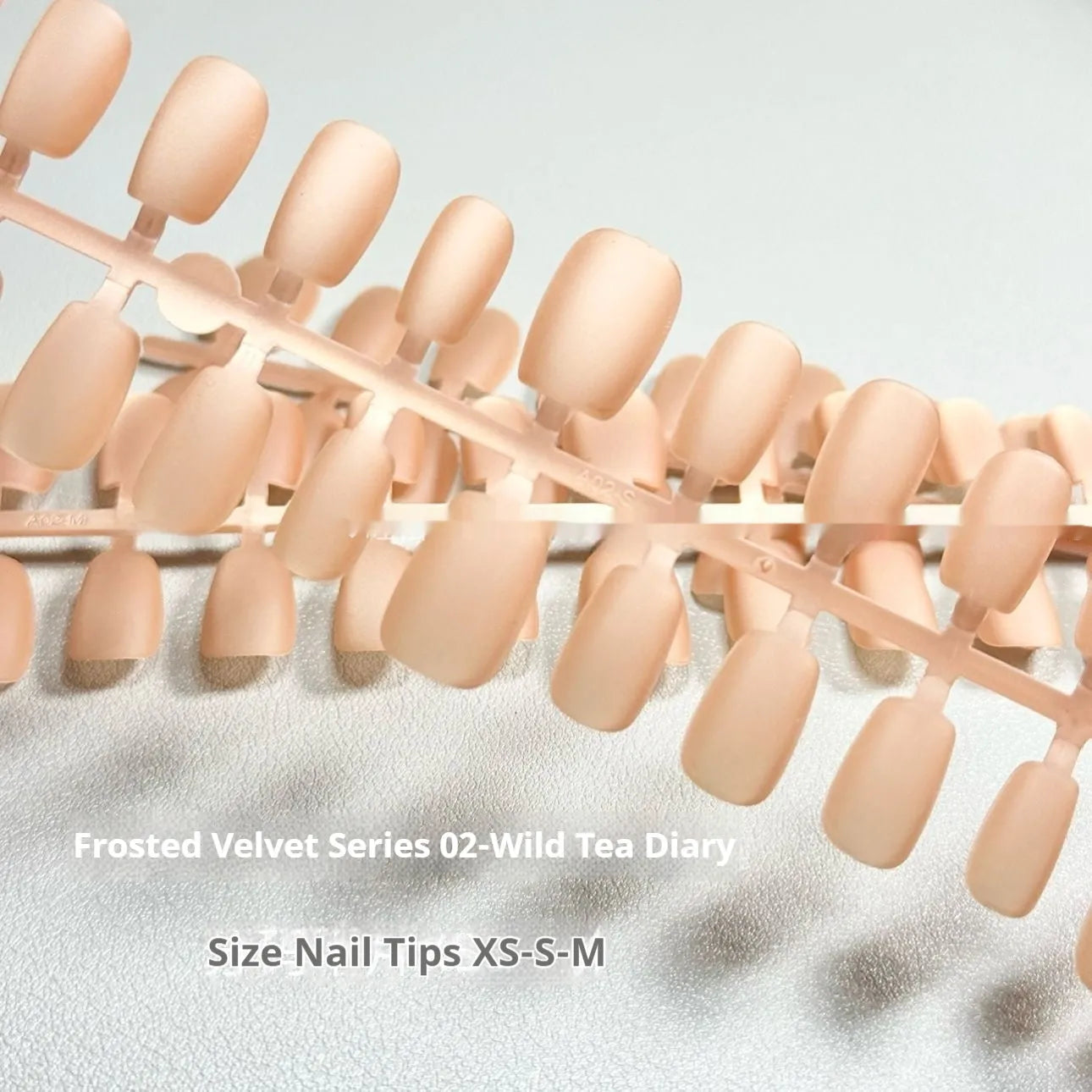 Frosted Velvet Cat's Eye false nail set with Aurora design on a clear background, showing short ladder sizes.