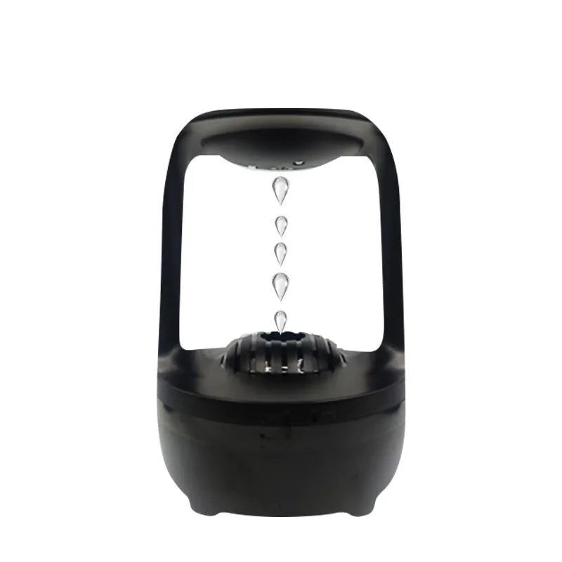 Black or white anti-gravity humidifier with water droplet effect on a desk.