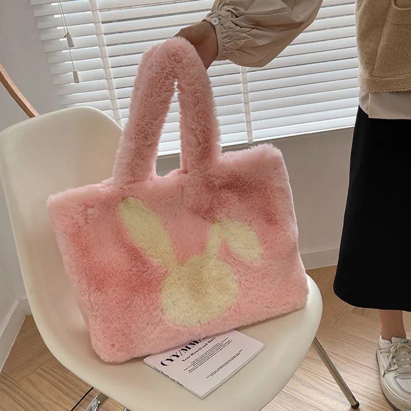 Soft plush shoulder bag with cartoon rabbit ears in one of six solid colours.