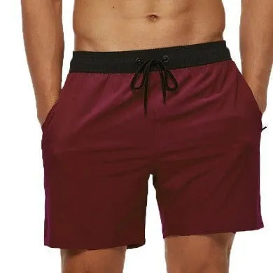 Men's blue drawstring shorts with a zippered pocket and stitching waist detail