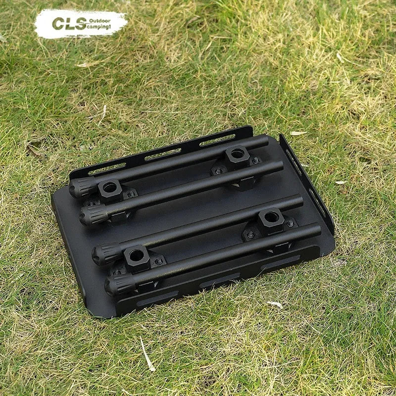 Aluminium folding camping stool that converts into a small table, shown with a tactical storage bag and a beige PU cushion.