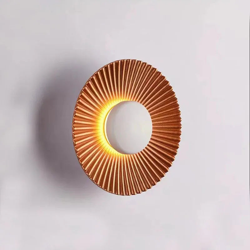Round aluminium wall lamp with LED light in a choice of colour finishes including white and gold.