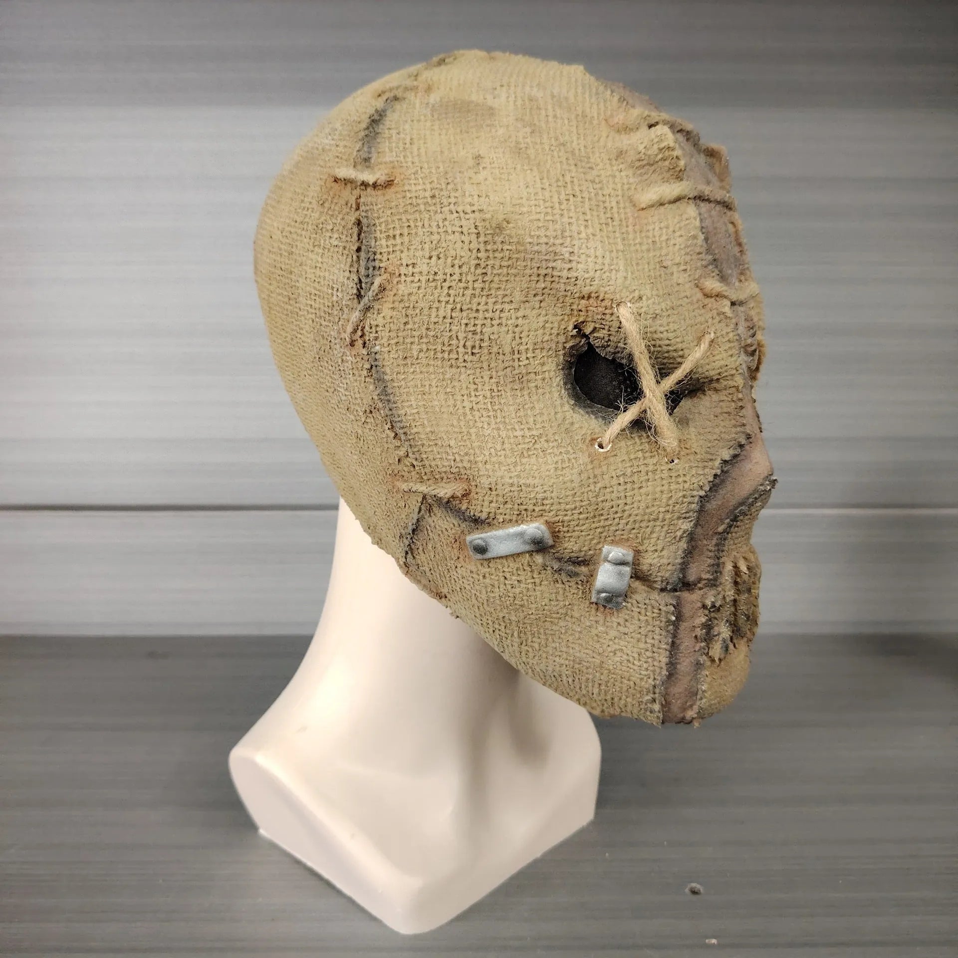 Close-up of a detailed latex scar skull mask head cover for adult Halloween costumes