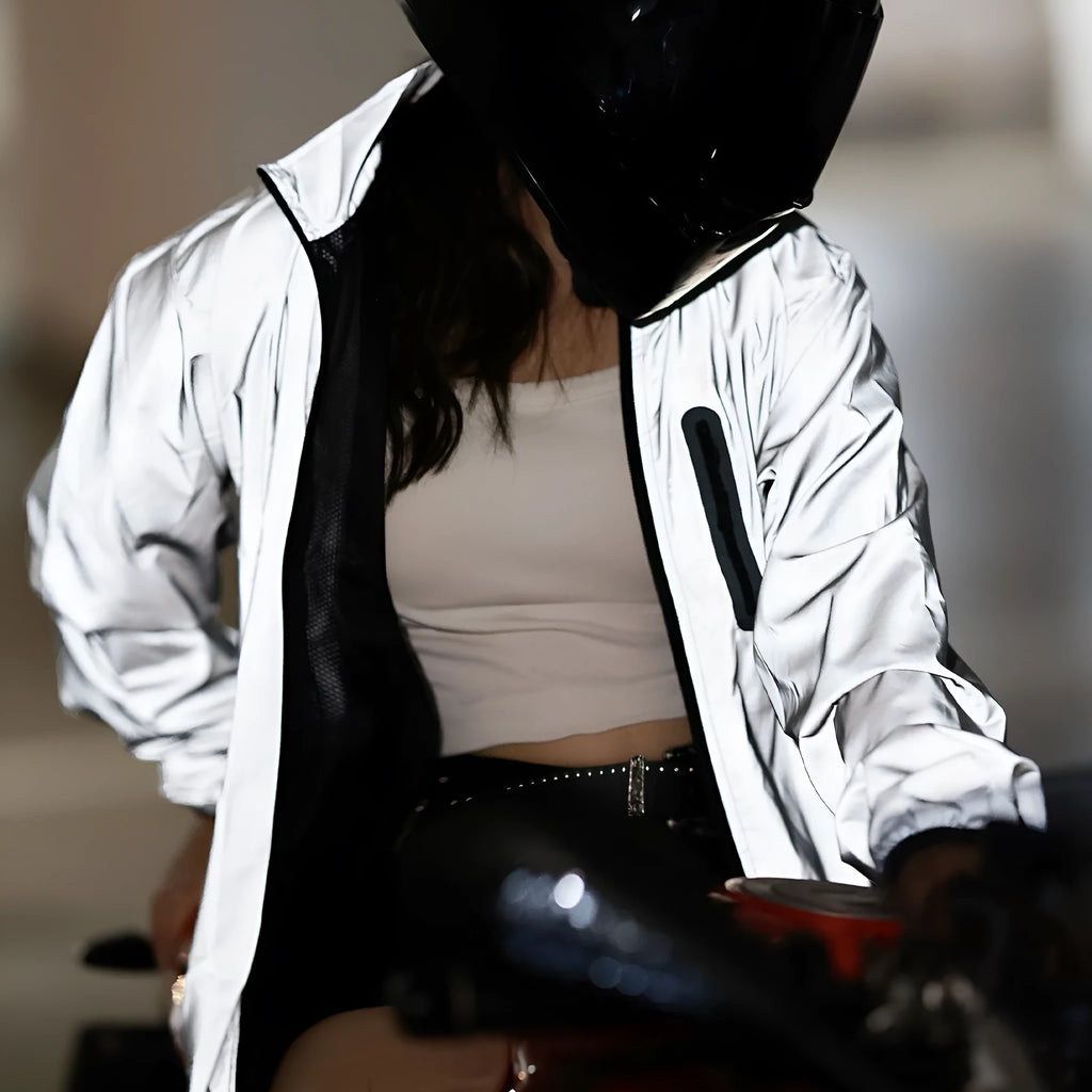 Silver waterproof polyester long sleeved top shown on a hanger.