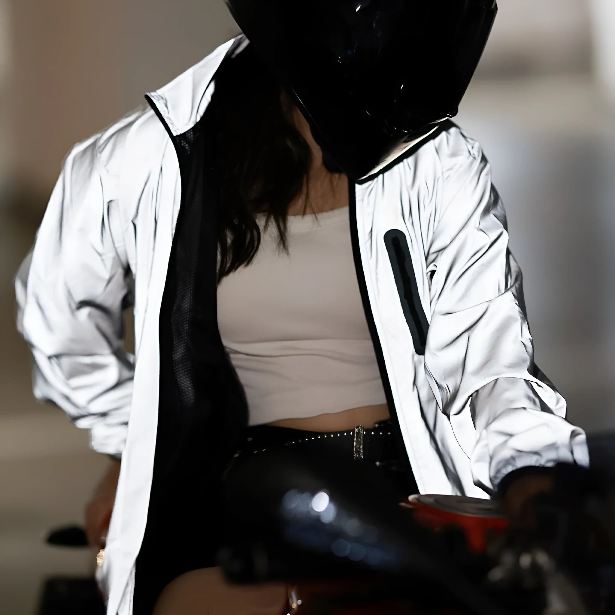 Silver waterproof polyester long sleeved top shown on a hanger.