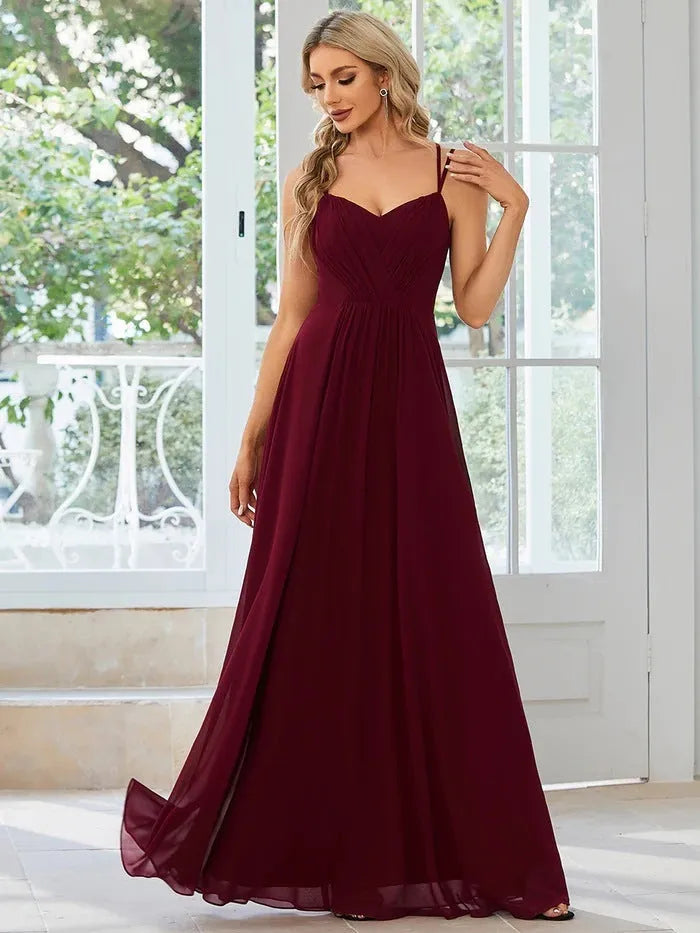 Women's sleeveless pleated A-line long dress in light green, shown in a solid colour with a long skirt.