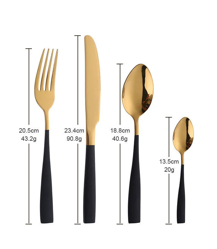 Four-piece stainless steel cutlery set with mirror-polished black finish laid out on a surface