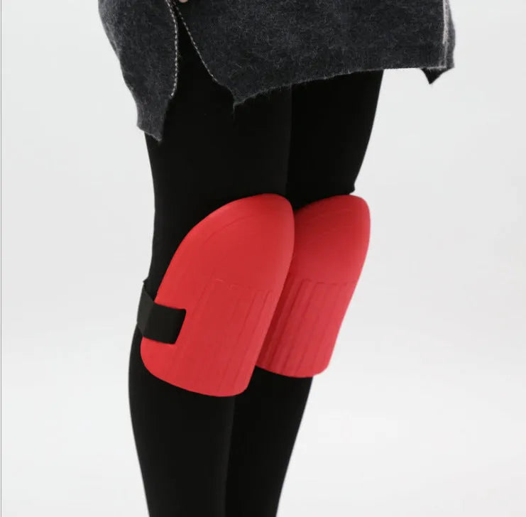 A pair of thick EVA foam kneepads in army green colour on a garden soil background.