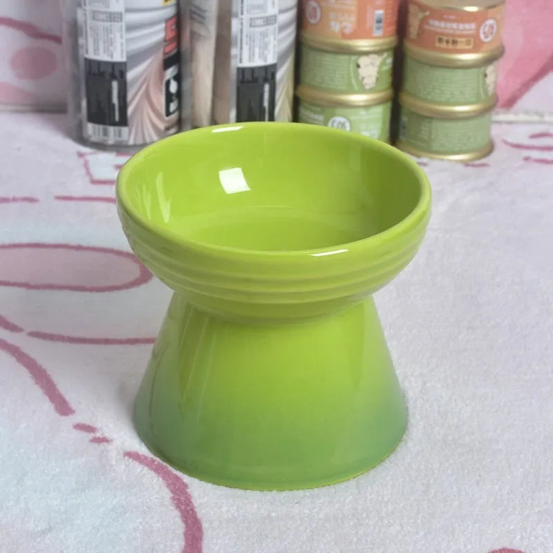 Black ceramic pet bowl with a raised foot and high neck guard for dogs and cats.