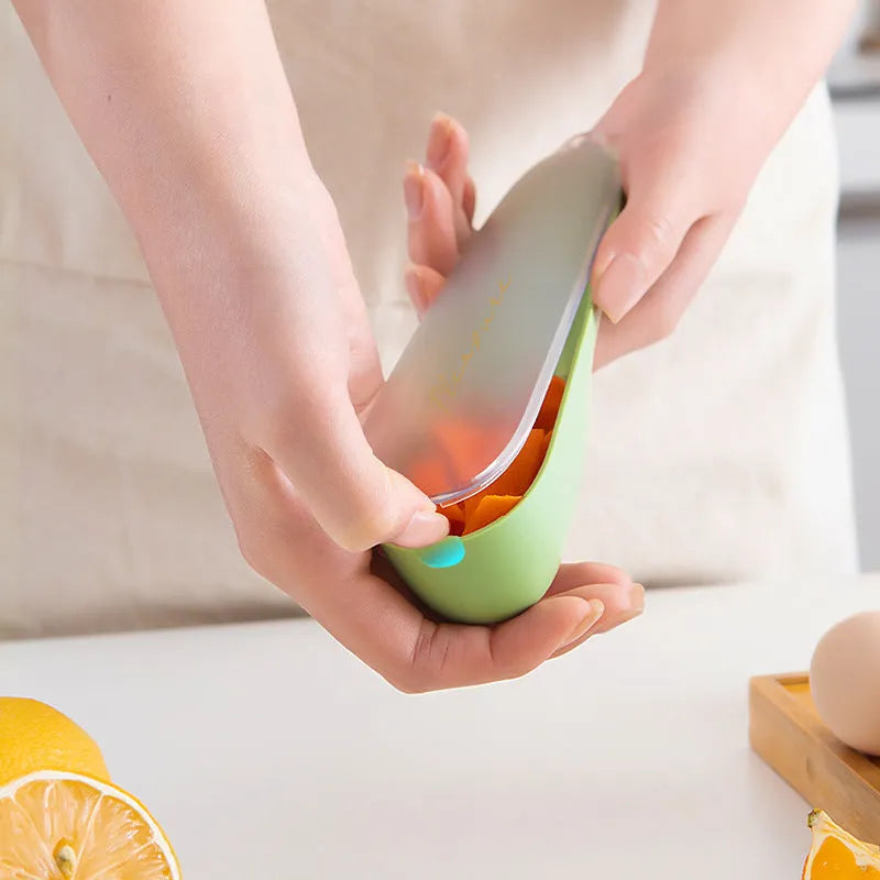 Dark green kitchen peeler with a stainless steel blade extended from its storage tube, showing the non-slip handle.