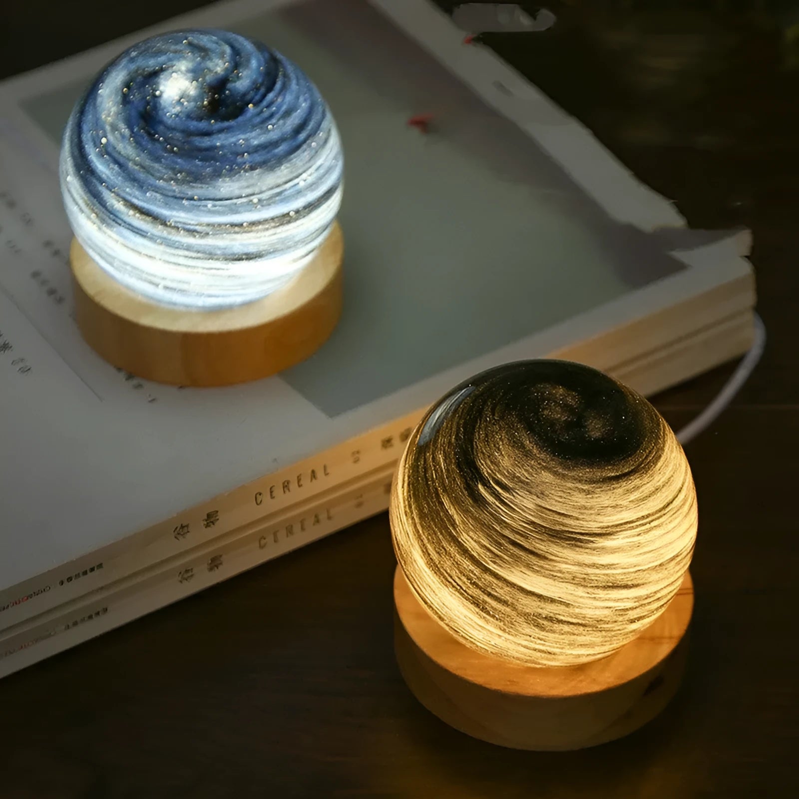 Compact modern planet USB night light on its base with dimmable three-colour lighting.