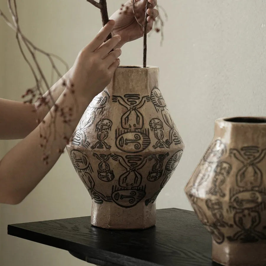 Hand-painted ceramic vase with vintage carved religious patterns in cylindrical shape