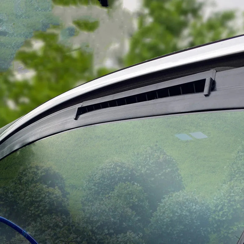 Black and white car ventilation fan for exhaust odour with USB cable on a car seat