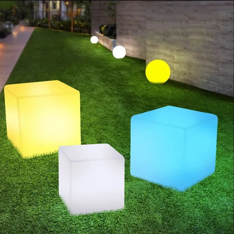 Square LED cube light stool in modern design showing waterproof PE construction with solar panel or charging port visible