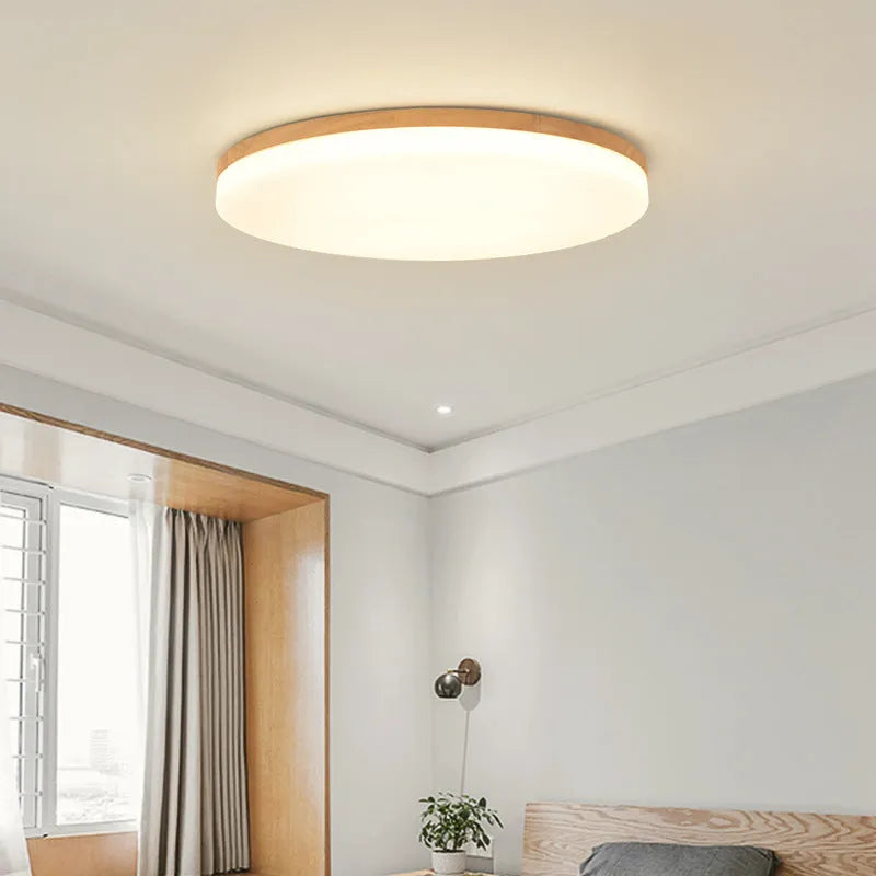 Japanese minimalist style ceiling lamp with a natural wood art body and a white acrylic diffuser shade.