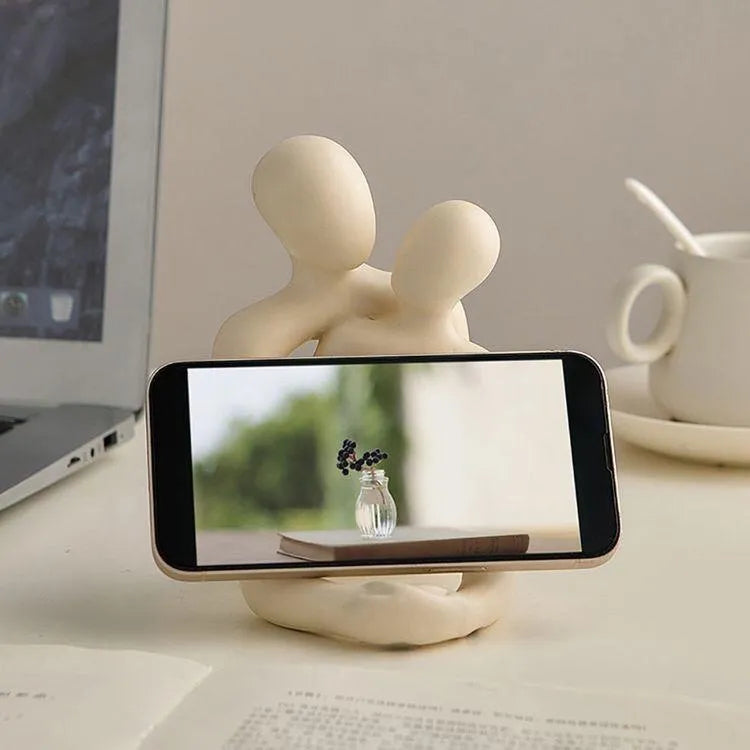 Modern minimalist loving couple resin statue in Gold or Milky White finish on a wooden surface.