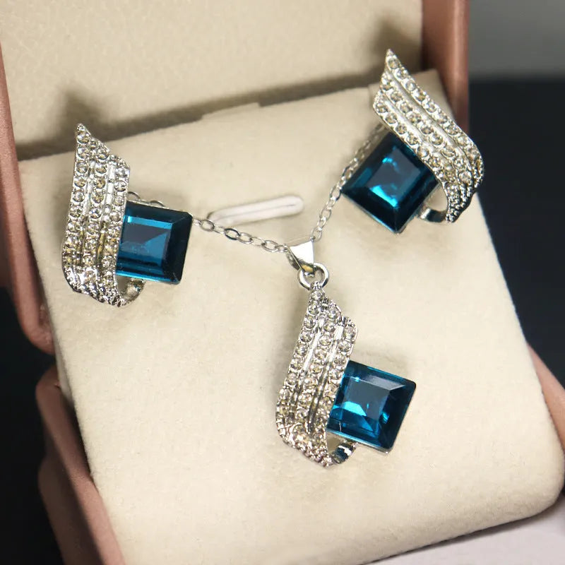 Gold-toned women's necklace and earring set with alloy, glass, and a cross chain, shown in two style options.