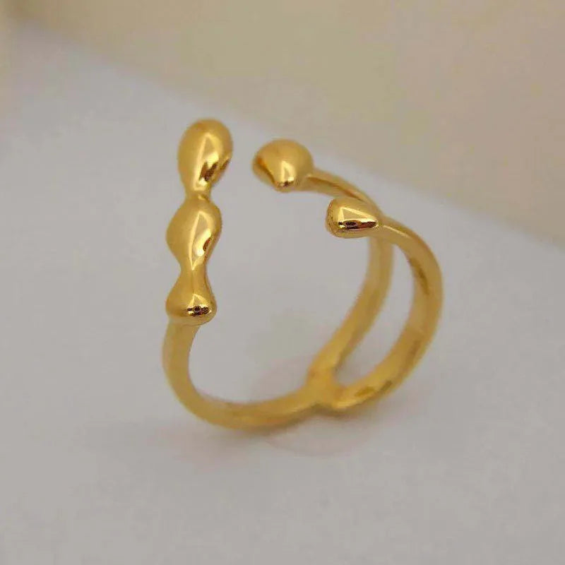 Women's brass opening ring with gold finish and circle sphere design