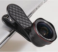 Black mobile phone wide-angle and macro lens kit with clip and storage case on a table.