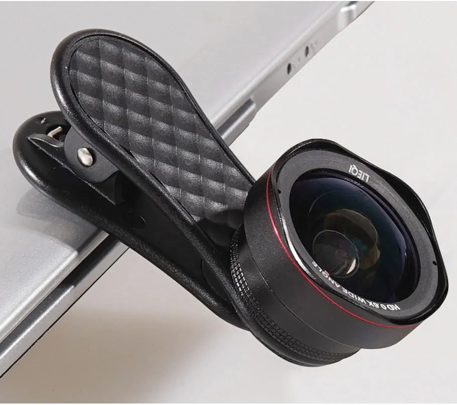 Black mobile phone wide-angle and macro lens kit with clip and storage case on a table.