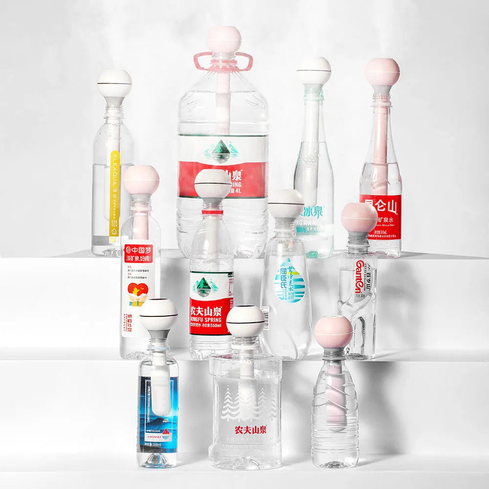 Pink and white columnar magic wand ultrasonic humidifier with USB cable.