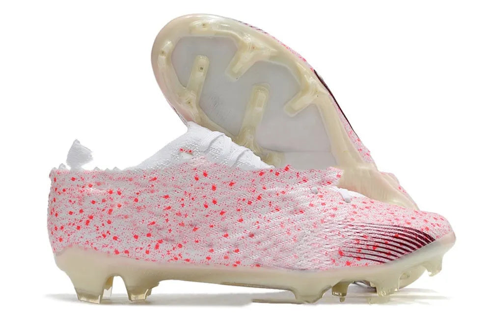 Men's low-top football shoes with knitted upper, lace-up front, and rubber sole with FG studs.