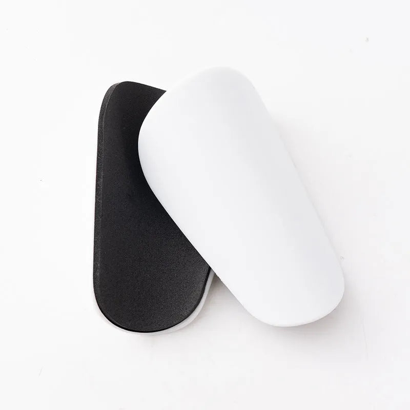 Pair of black PU mini shin guards for sports protection, showing S size.