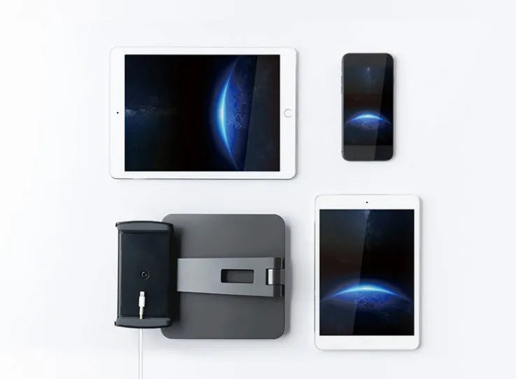 Folding aluminium phone and tablet stand on a desk, shown in silver colour with 360-degree rotation.