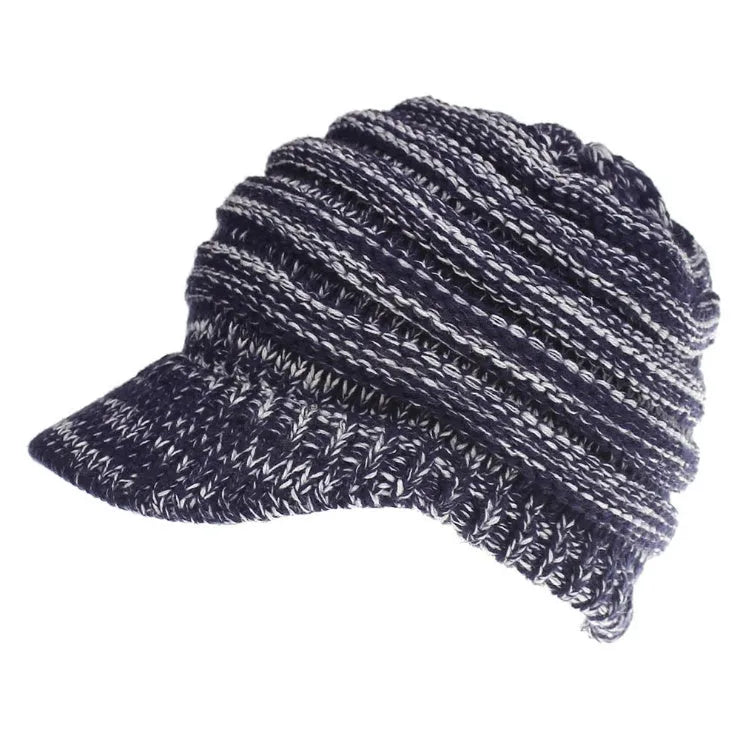 Woman wearing a soft knitted beanie with a ponytail pulled through the hole at the back.