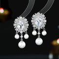 Copper oval earrings with zircon inlaid detail and pearl tassel pendant in light purple colour