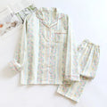 Women's striped cotton gauze long-sleeved top and matching trousers two-piece lounge set laid flat.