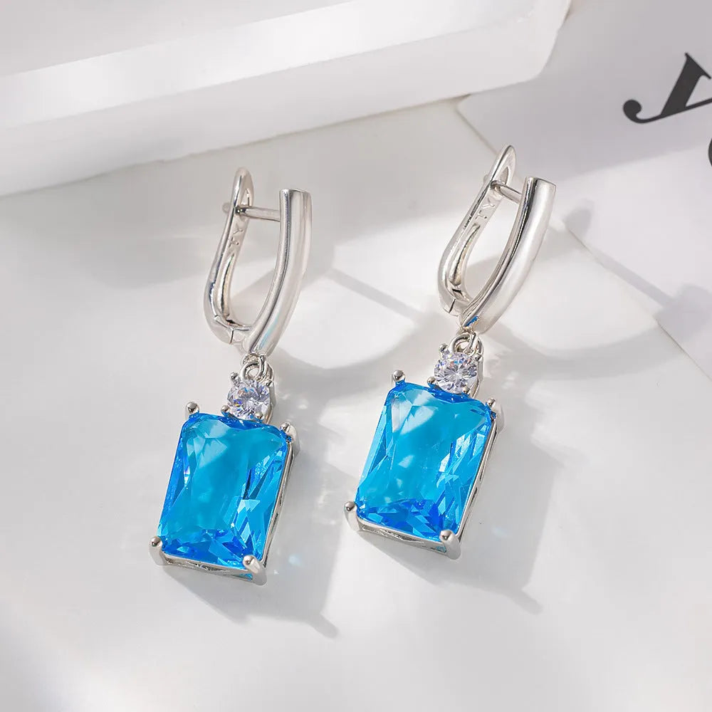 Square geometric copper earrings with gold electroplated finish showing quadrilateral shape
