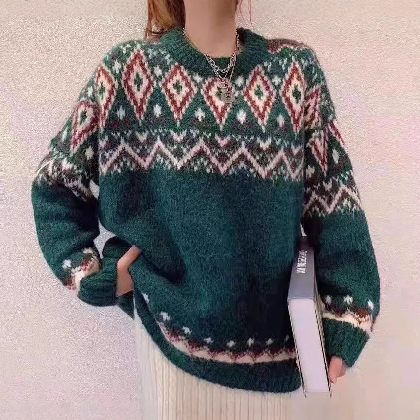 Red and white striped loose fit pullover knitted top with long sleeves on a mannequin.