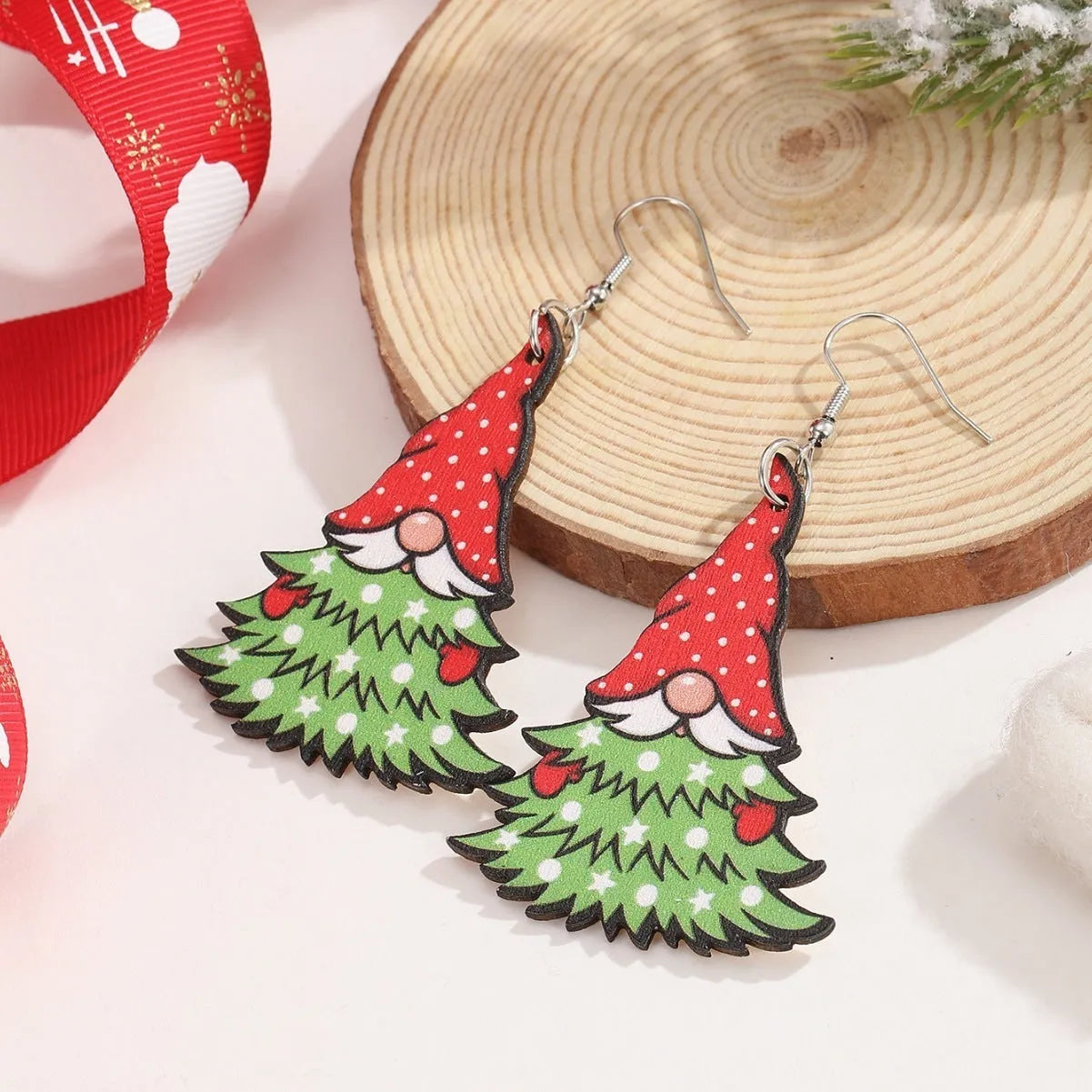 Women's wooden Christmas earrings with geometric tree and snowman shapes featuring Santa Claus elements