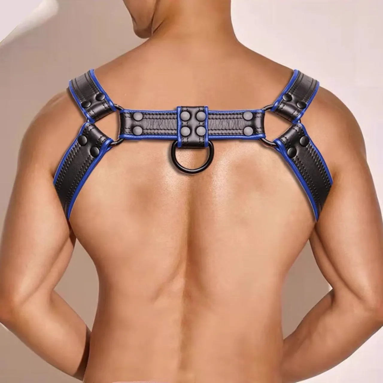 Blue and black leather adjustable shoulder strap with metal buckle and rivet hardware for binding restraint use