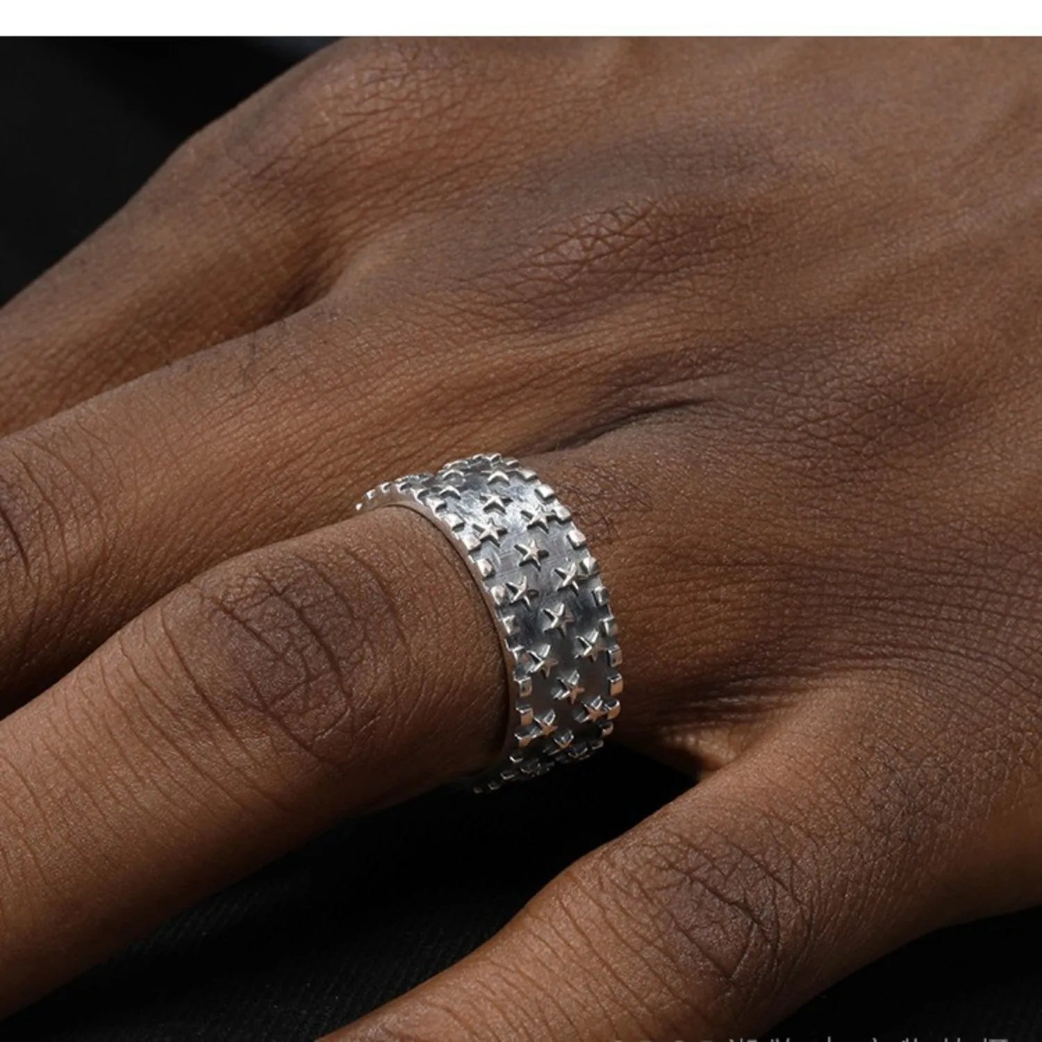 Adjustable silver ring with geometric five pointed star pattern on adjustable band