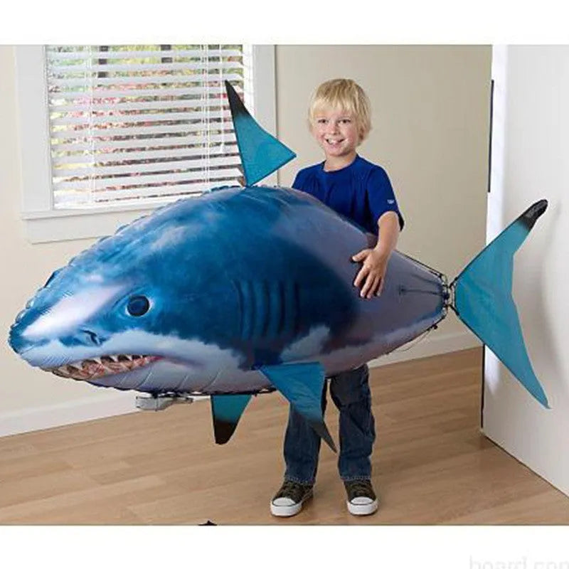 Large remote control Shark inflatable balloon toy flying indoors with side-swaying tail.